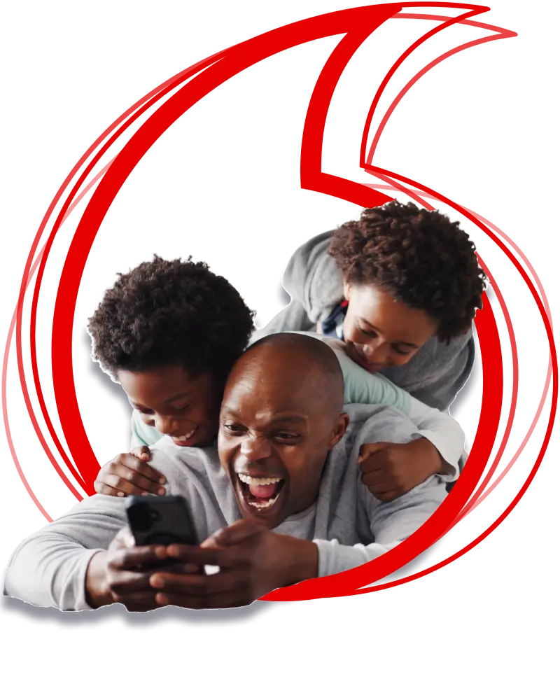 A cheerful man laughing while looking at his smartphone with two young boys playfully leaning on his back, framed inside a large red Vodacom speech mark logo outline.