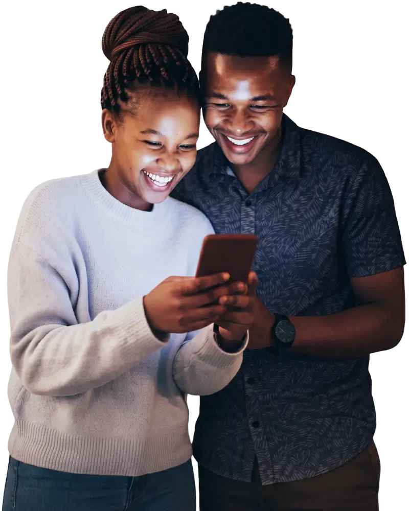 A smiling young woman and man looking together at a smartphone screen against a dark background