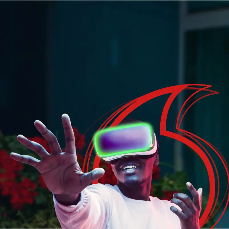 A man wearing a glowing VR headset reaching out toward the camera.