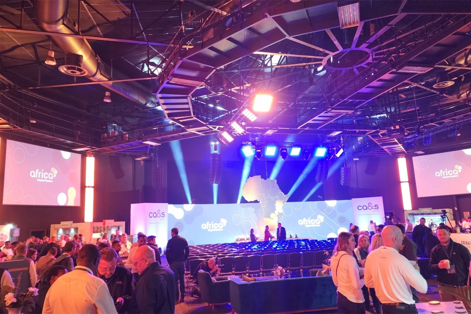Crowded conference hall with stage lighting and digital screens at the CA&S Group Africa event